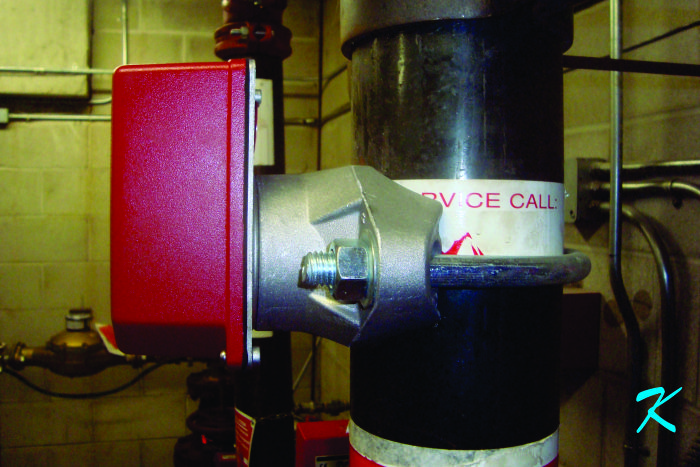 A waterflow switch is attached to the fire suppression sprinkler pipe